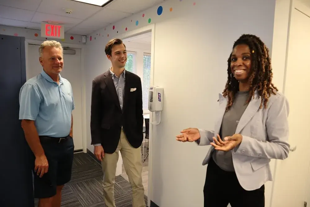 Founder Alisha Simpson-Watt speaking with visitors at Collaborative ABA Services