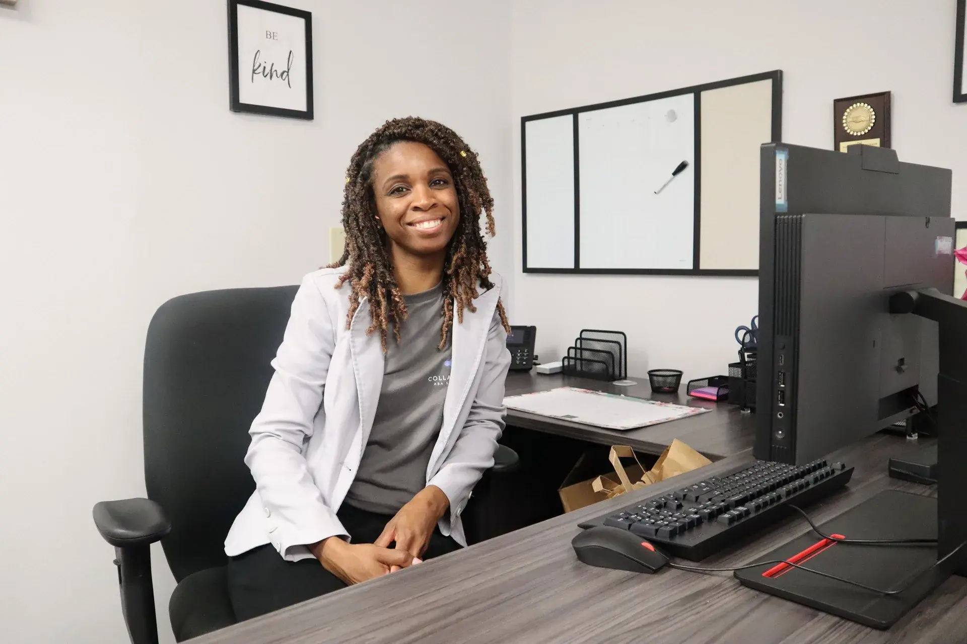 Alisha Simpson-Watt, Executive Clinical Director and Founder of Collaborative ABA Services, LLC, seated at her desk