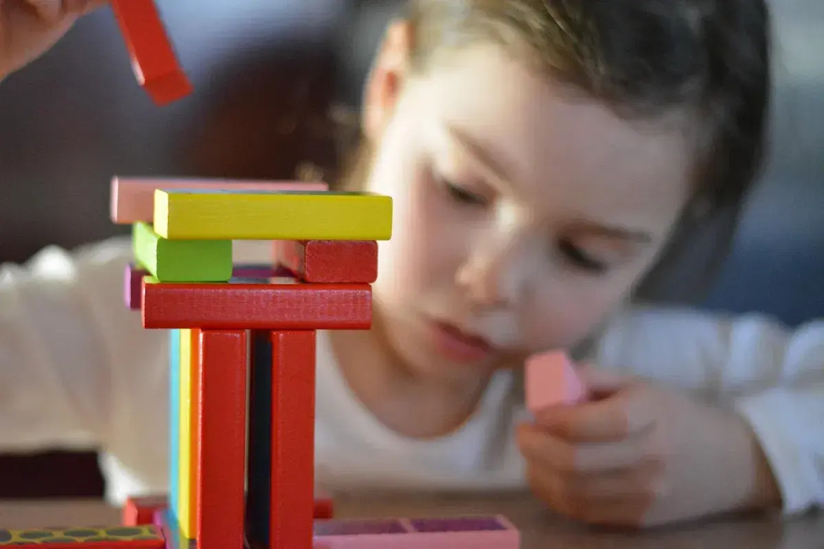 Child building with colorful blocks during a hands-on learning activity